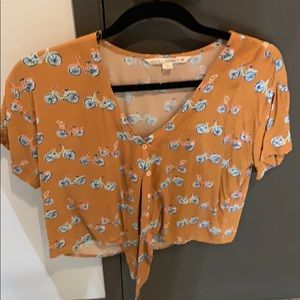 Yellow top with bikes and a tie in front